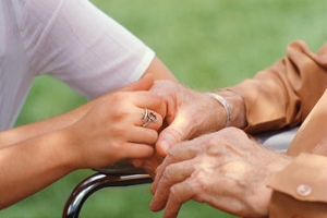 young hands touching elderly hands